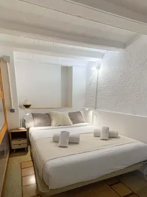 a white bedroom with two beds in a room at Barcelona Touch Apartments - Font Honrada in Barcelona
