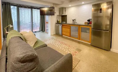 a living room with a couch and a kitchen at Barcelona Touch Apartments - Font Honrada in Barcelona