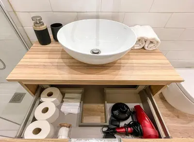 a bathroom counter with a sink and toiletries at Barcelona Touch Apartments - Fontrodona in Barcelona