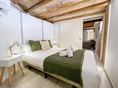 a bedroom with a bed with towels on it at Barcelona Touch Apartments - Creu dels Molers in Barcelona