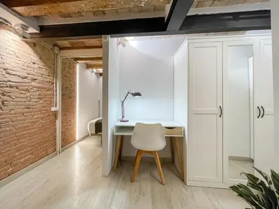 a room with a white desk and a chair at Barcelona Touch Apartments - Creu dels Molers in Barcelona