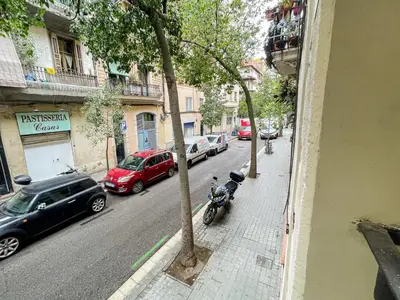 a street with cars parked on the side of the road at Barcelona Touch Apartments - Creu dels Molers in Barcelona
