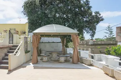 a gazebo with a table and a bench at Can cruspinera WITH 6BEEDROOM in Tiana