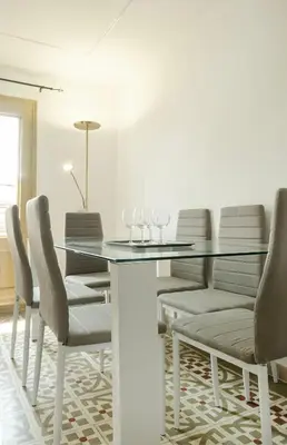 a dining room with a glass table and chairs at Catalan Charm 3BR w 15 Baths in Barcelona