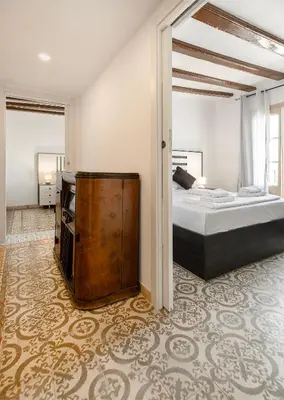 a bedroom with a bed and a dresser in it at Catalan Charm 3BR w 15 Baths in Barcelona