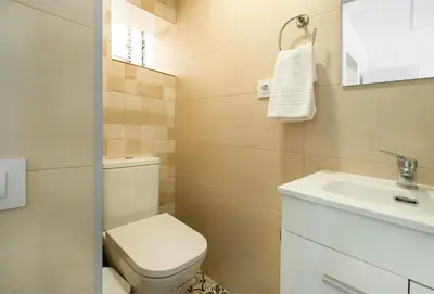 a small bathroom with a toilet and a sink at Catalan Charm 3BR w 15 Baths in Barcelona