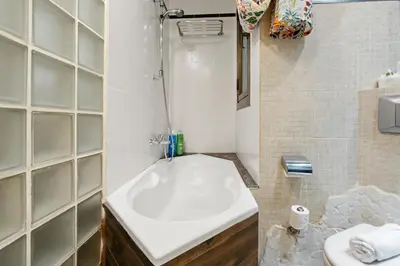 a walk in closet with wooden shelves at Steps to Sagrada Família AC Elevator in Barcelona