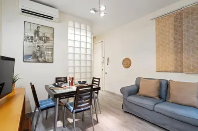 a living room with a couch and a table at Steps to Sagrada Família AC Elevator in Barcelona