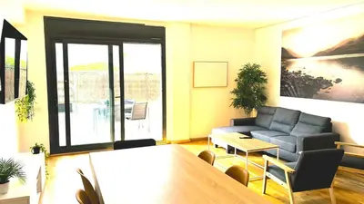 a living room with a couch and a table at Apartamento independiente con jardín in Terrassa