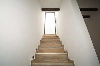 a stairway leading up to a window in a building at Casa con piscina en el centro de Calella, Aire in Calella