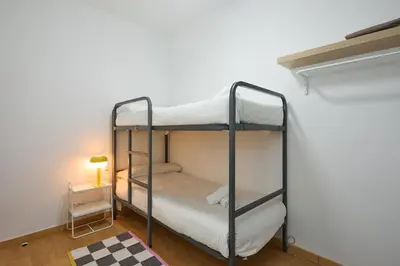 a bedroom with two bunk beds and a lamp at Park Guell in Barcelona