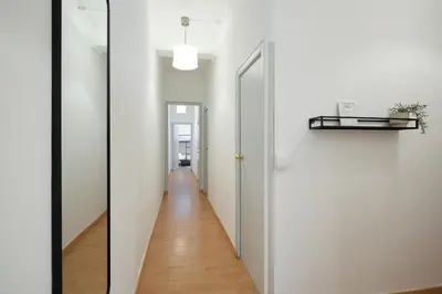 a hallway with white walls and a white door at Park Guell in Barcelona