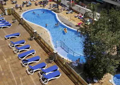 an overhead view of a swimming pool with chairs and people at Hotel Bon Repos in Calella