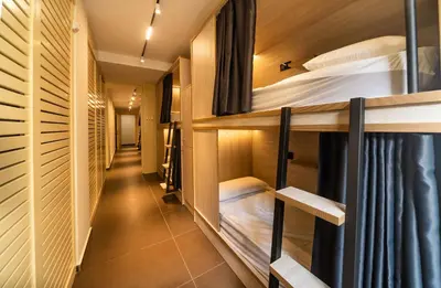 a corridor of a dorm room with bunk beds at GG Hostel in Barcelona