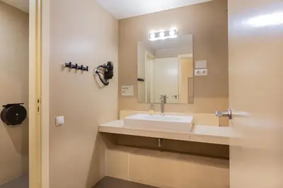 a bathroom with a sink and a mirror at GG Hostel in Barcelona