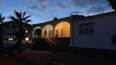 a house with its lights on at night at Ibiza style villa with swimming pool near Sitges in Cunit