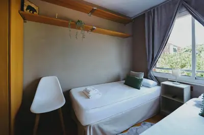a small room with a bed and a window at 3 bedroom Huge apartament near the beach in Sant Adria de Besos