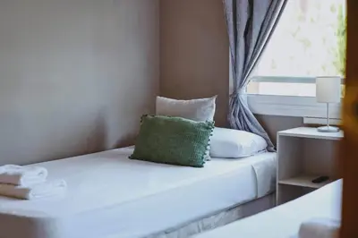 a bedroom with a bed with a pillow and a window at 3 bedroom Huge apartament near the beach in Sant Adria de Besos