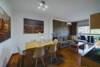 a living room with a table and a couch at 3 bedroom Huge apartament near the beach in Sant Adria de Besos
