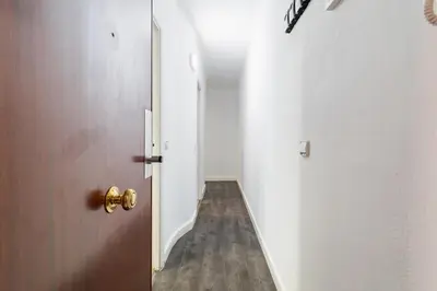 an empty corridor with a door and a hallway at Toledo House Self Checkin in Hospitalet de Llobregat