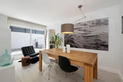 a dining room with a wooden table and chairs at Namasté by Seaside Homes in Castelldefels