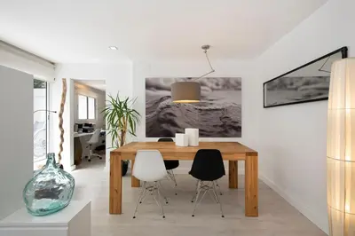 a dining room with a wooden table and chairs at Namasté by Seaside Homes in Castelldefels