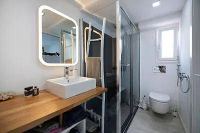 a bathroom with a sink and a mirror and a shower at Namasté by Seaside Homes in Castelldefels