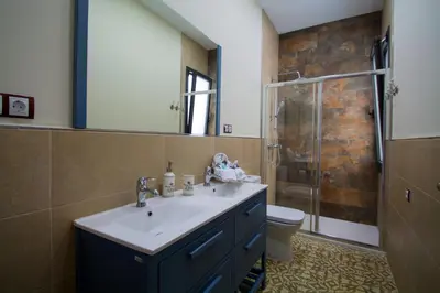 a bathroom with a sink and a shower and a toilet at Casa grande con piscina en el centro de Calella, Tramuntana in Calella