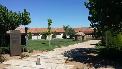 a house with a garden and a sign in front of it at Mas de la Sala in Sallent del Llobregat
