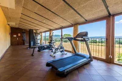 a gym with two treadmills and a treadmill at Mas de la Sala in Sallent del Llobregat
