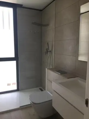 a bathroom with a toilet and a sink and a window at Casa de lujo en Gavá mar in Gavà
