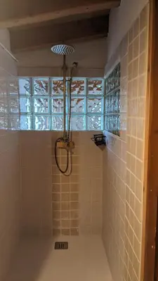 a shower in a bathroom with a tile wall at La Coma in gualba de Dalt