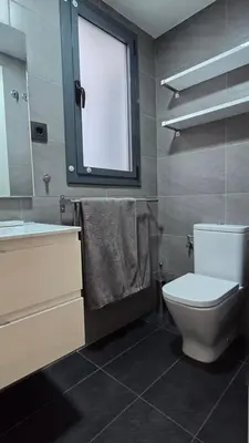 a bathroom with a toilet and a sink and a window at Opening Doors Summer Chic in Barcelona