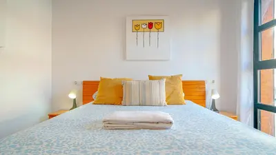 a bedroom with a bed with two towels on it at Vivalidays Margarita - Pineda de Mar in Pineda de Mar