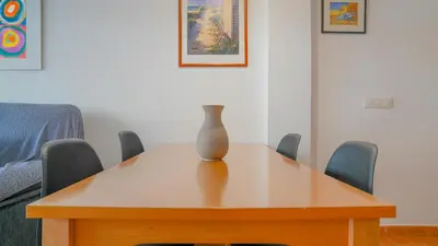 a vase sitting on top of a wooden table at Vivalidays Margarita - Pineda de Mar in Pineda de Mar