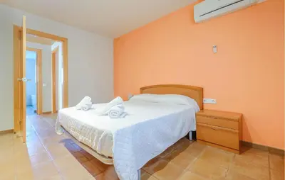 a bedroom with a bed with two towels on it at Lovely Home In Segur De Calafell in Segur de Calafell