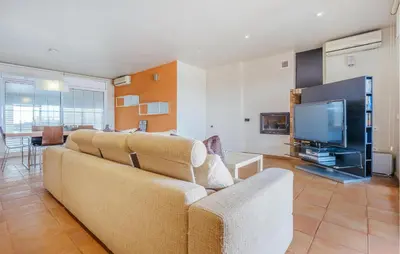 a living room with a couch and a television at Lovely Home In Segur De Calafell in Segur de Calafell