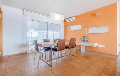 a dining room with a table and chairs and a window at Lovely Home In Segur De Calafell in Segur de Calafell
