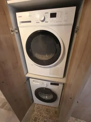a washer and dryer sitting on a shelf in a room at Two bedrooms bright apartment center Barcelona in Barcelona