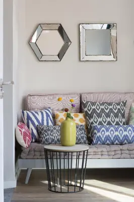 a living room with a couch with pillows and a table at The Conica Deluxe Bed&Breakfast in Barcelona