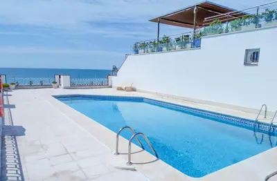 a swimming pool with a view of the ocean at Stunning sea views over marina with swimming pool in Sitges