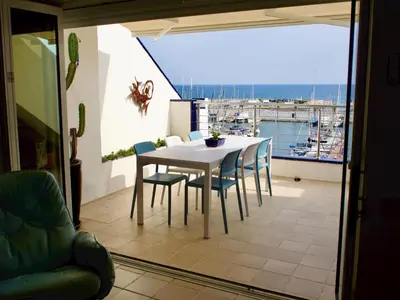 a kitchen with a sink and blue tiles on the wall at Stunning sea views over marina with swimming pool in Sitges