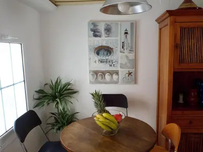 a room with a desk with a television and shelves at Stunning sea views over marina with swimming pool in Sitges