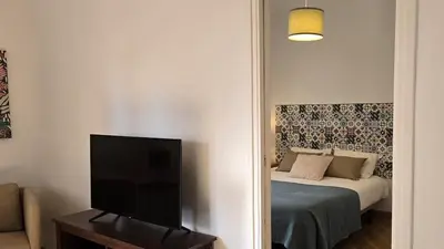 a bedroom with a bed and a flat screen tv at Opening Doors Sant Pau II Centric AACC in Barcelona