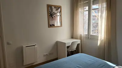 a bedroom with a bed and a desk and a window at Opening Doors Sant Pau II Centric AACC in Barcelona