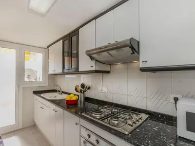 a white kitchen with a stove and a sink at Apartment Bahia by Interhome in Cunit