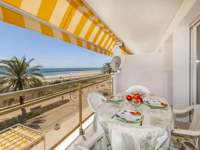 a dining room with a table and chairs and the beach at Apartment Bahia by Interhome in Cunit