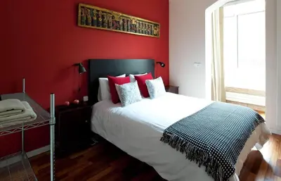 a red bedroom with a bed with red walls at Barcelona - Provença in Barcelona