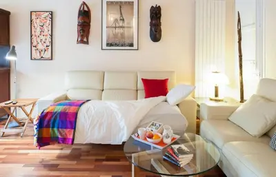 a living room with a bed and a couch at Barcelona - Provença in Barcelona