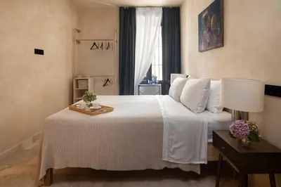 a bedroom with a bed and a large mirror at Hotel Vella Nit in Canet de Mar